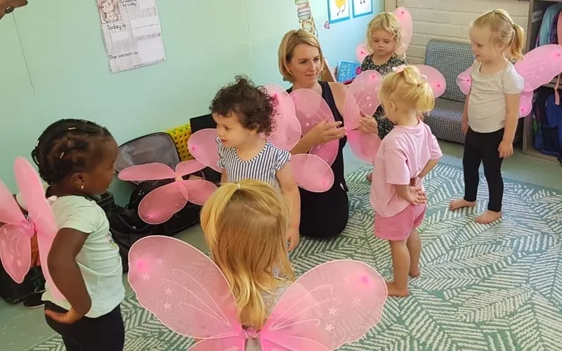 Young children in fairy wings during a ballet class