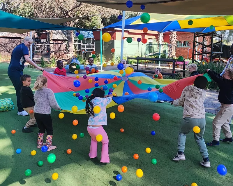 Children playing a parachute game in the playground