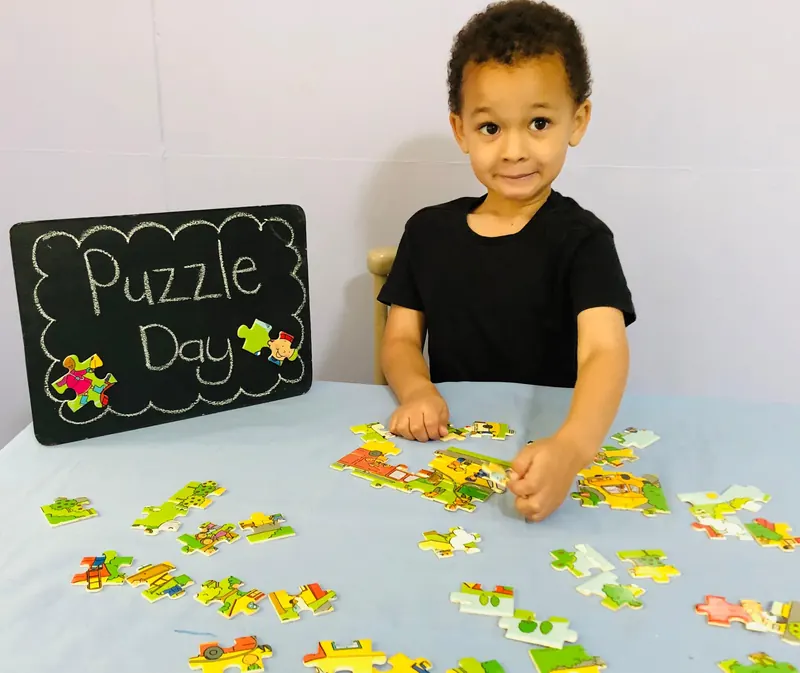 A child sorting puzzle pieces at a table